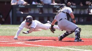fordham baseball player sliding into home