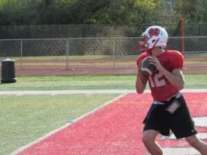 football player practicing with gorout device on waist