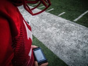 football player looking at gorout device