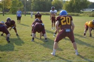 football practice with coach watching on 
