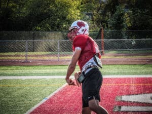 quarterback throwing pass at practice