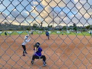 youth softball view from behind home plate