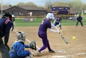 softball player hitting ball in game