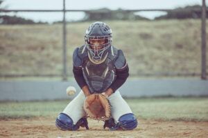 baseball catcher blocking a pitch