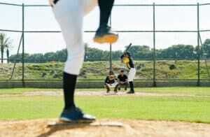 pitcher throwing to catcher with batter and ump in frame