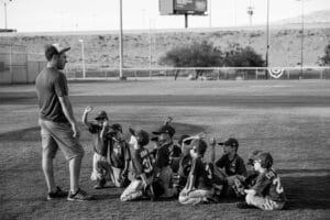 youth baseball coach talking to team
