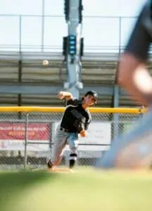 youth baseball pitcher throwing in game