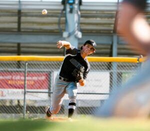 youth baseball pitcher throwing in game