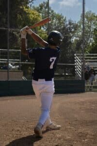 youth baseball player swinging on deck