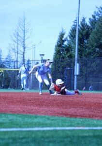 softball fielder tagging sliding baserunner at base