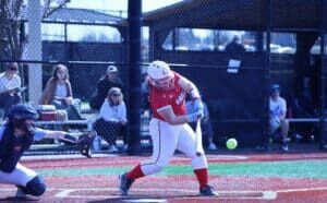 softball hitter swinging at pitch in game