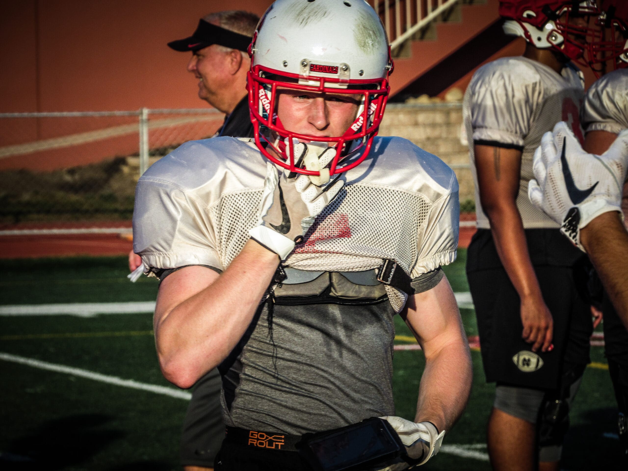football player places mouthguard in at practice