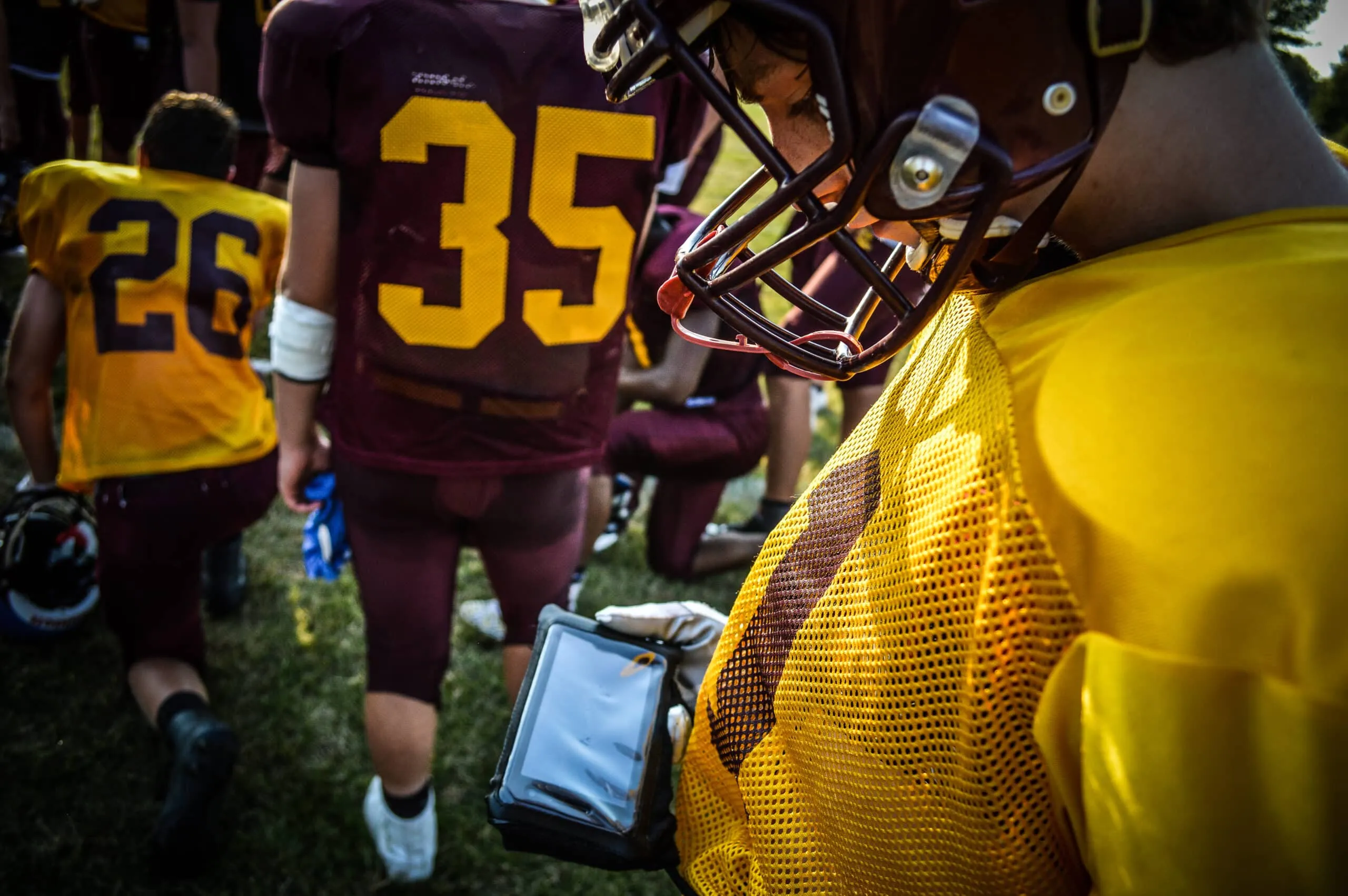 football player reviewing play on gorout device during break