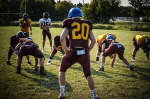 Linebacker lines up in defensive formation at football practice