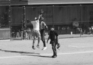 softball coach and player jumping high five