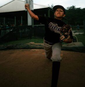 youth baseball pitcher at release point of mechanics
