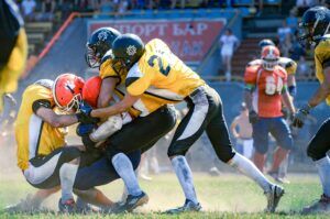football defensive linemen hustling to make tackle 