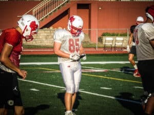 north central college football player looking at gorout device at practice