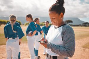 softball coach filling out lineup card