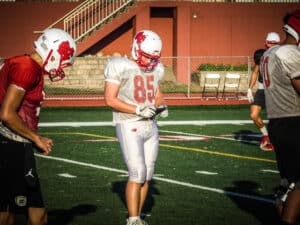 north central college football player looking at gorout device at practice