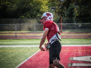 quarterback throwing pass at practice