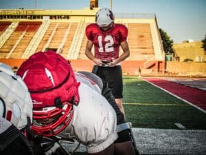 quarterback looking at gorout device during practice