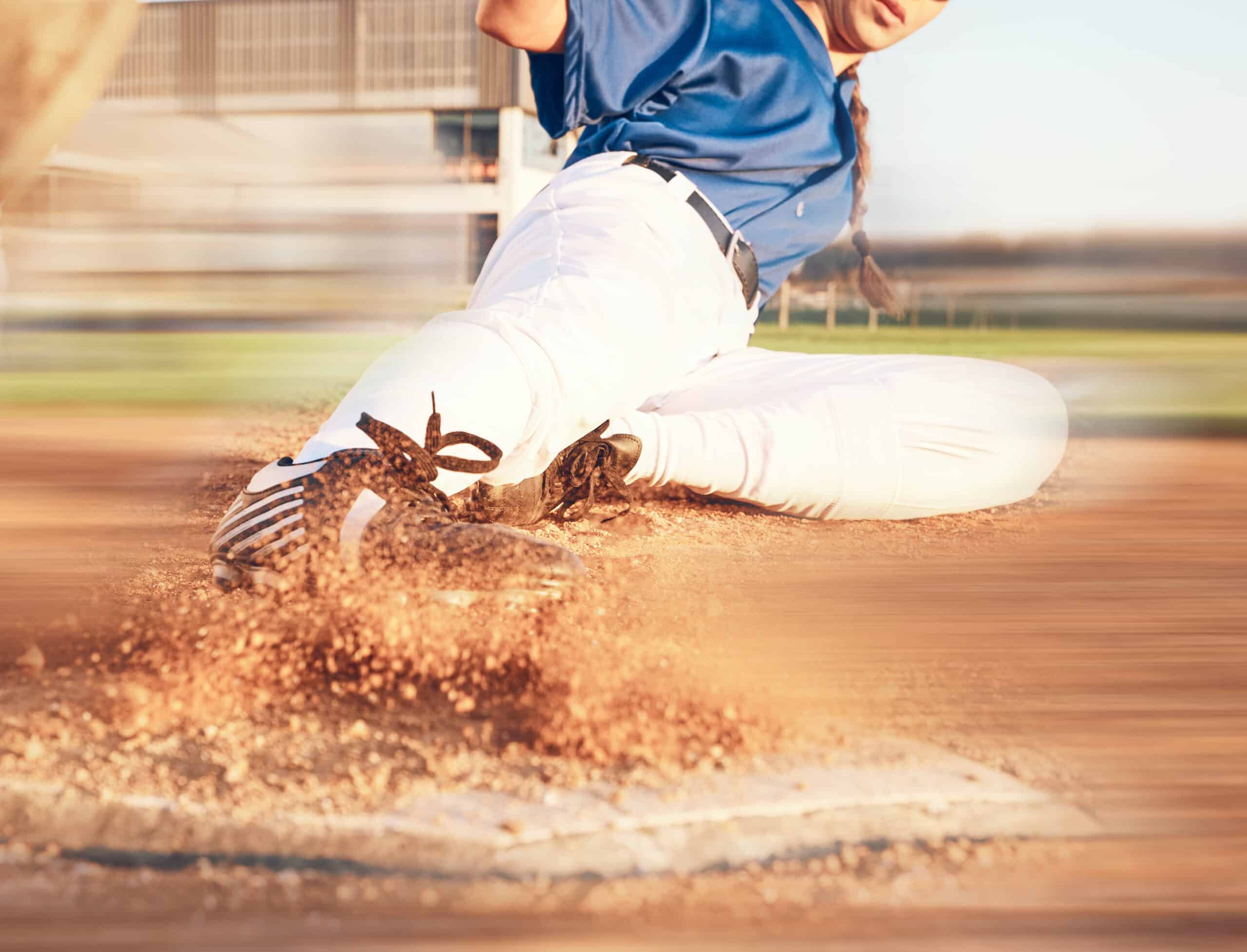 softball player sliding into home plate