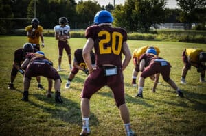 defensive players lined up at practice