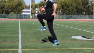 Athlete performing high knees either as a part of their agility work or a warm up for training