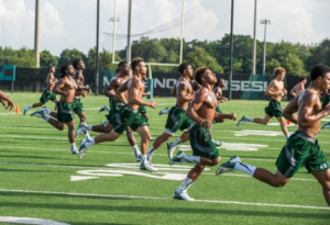 Players running interval sprints at football practice