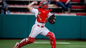 College catcher attempting to throw out a runner stealing second base