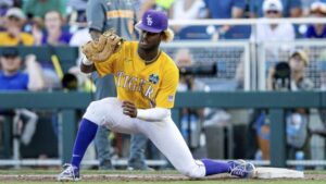 College first baseman scooping a short hop to record an out at first