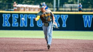 College shortstop underhands the ball to second base to start the turn on a double play