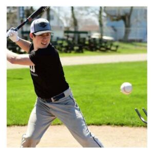 Youth baseball player doing front toss hitting drills