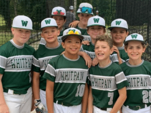 Youth baseball players pose for a picture after a game