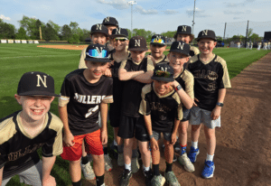 Travel baseball team poses for a picture after finishing a game