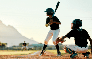 left handed youth baseball player batting in game