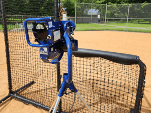 baseball pitching machine on practice field