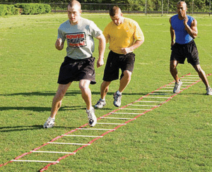 baseball players training using agility ladder