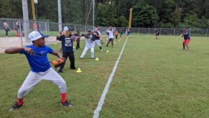 youth baseball players participating in throwing drill 