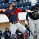 baseball catcher winds up to throw