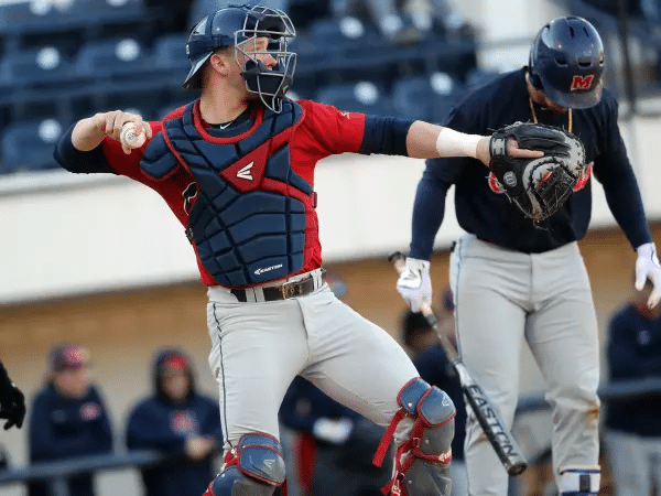 baseball catcher winds up to throw