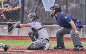 baseball catcher receiving pitch with ump watching