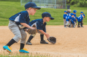 youth baseball players fielding ground balls at practice