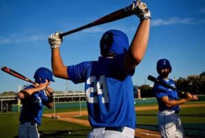 baseball player stretches bat over shoulders