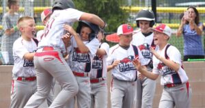 youth baseball team celebrates offensive play