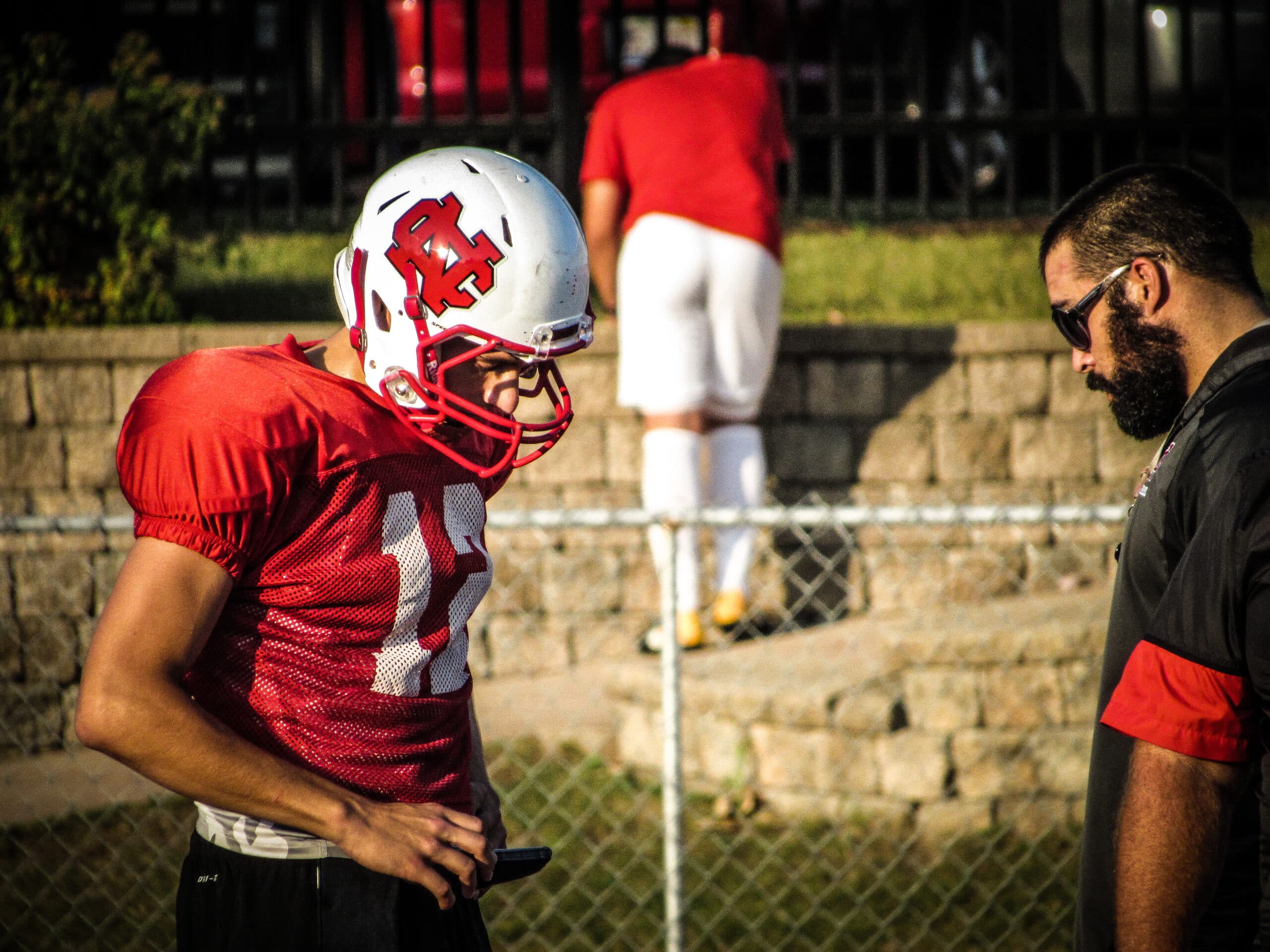football coach working with quarterback to use gorout device