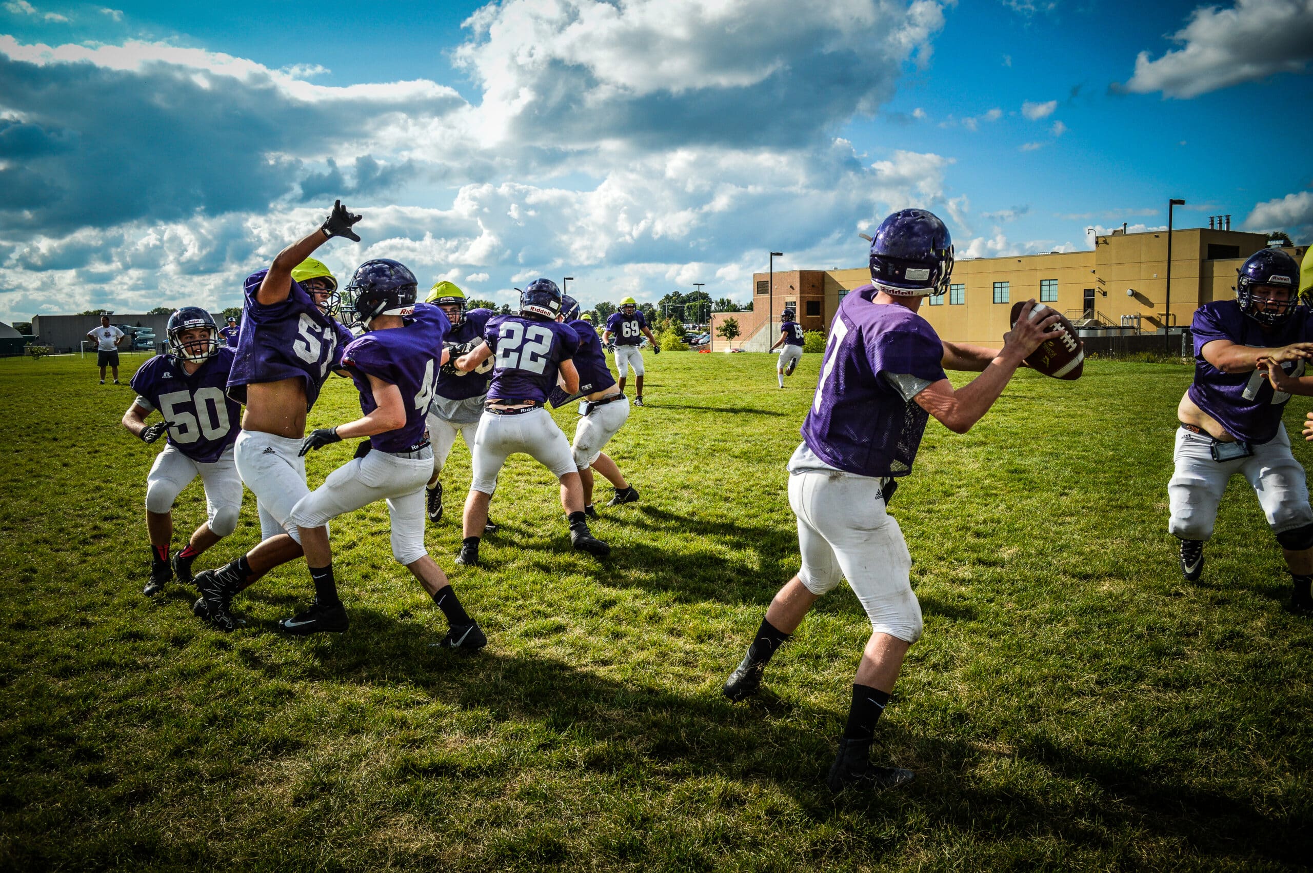football quarterback steps to throw pass in practice
