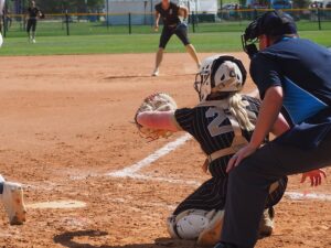 softball catcher receiving pitch