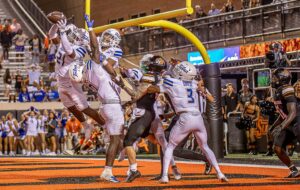 football players intercepting pass in end zone